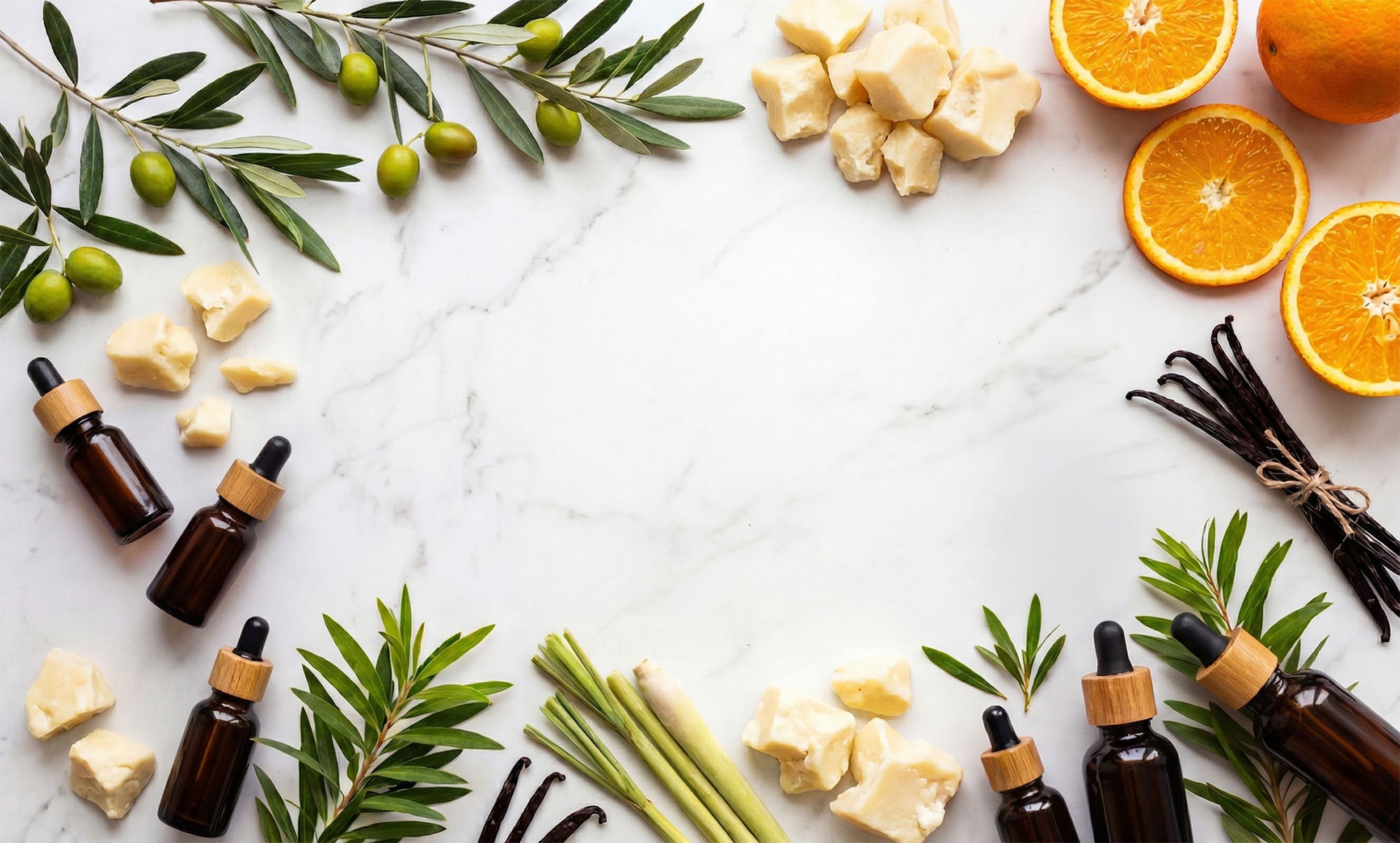 Essential oil bottles with natural ingredients on a marble surface