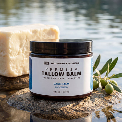 Jar of William Brook Tallow Co. Premium Tallow Balm with soap and olive branch on a natural background